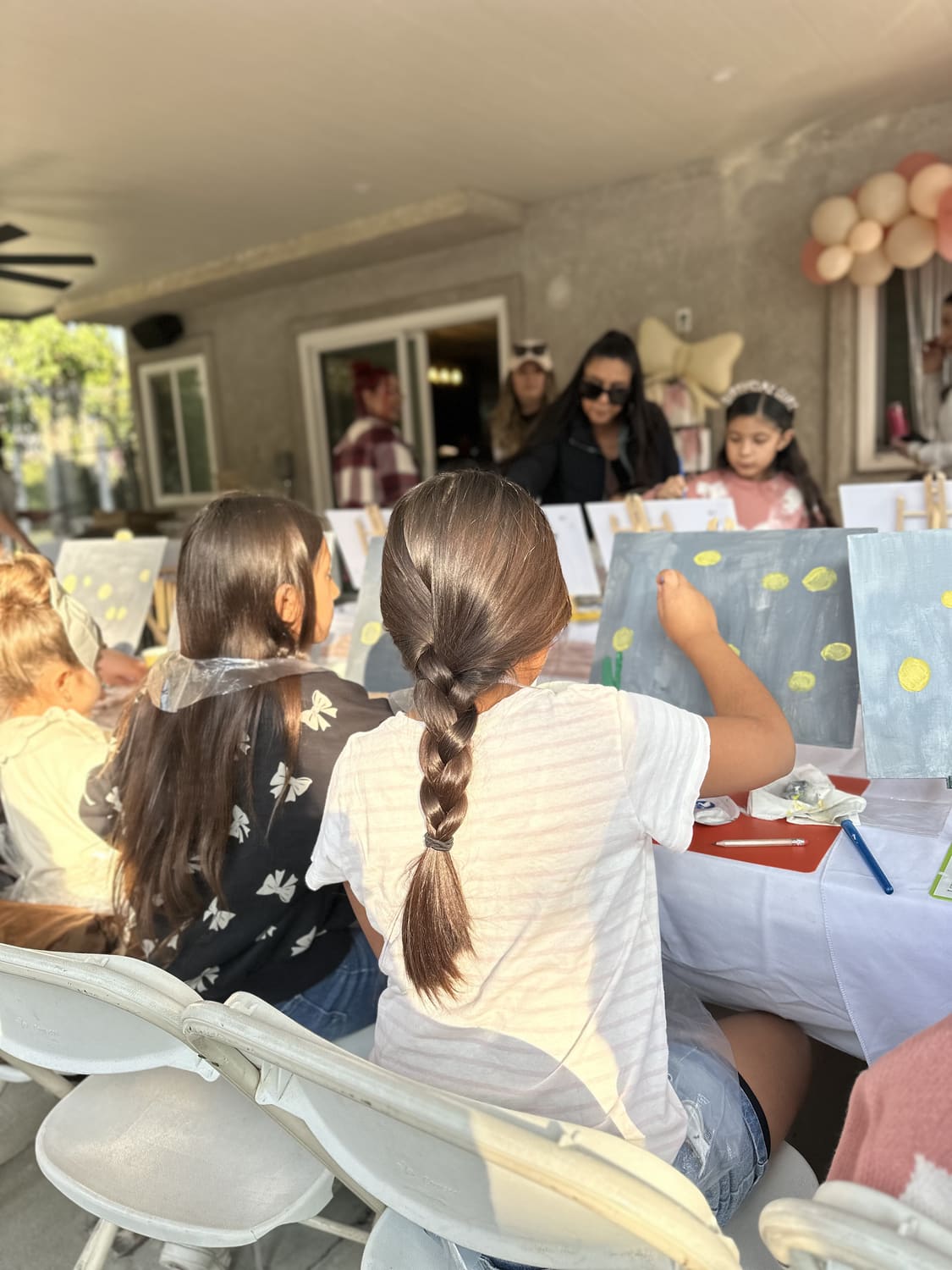 Guests celebrating a birthday with their finished paintings